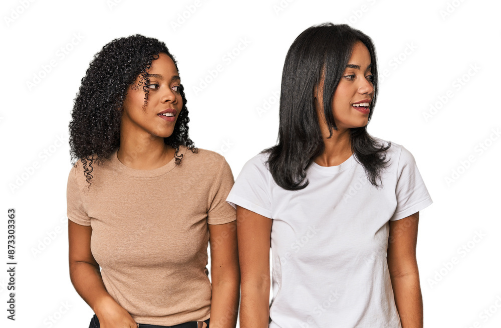 Young Latin friends in studio looks aside smiling, cheerful and pleasant. Young Latin friends in studio looks aside smiling, cheerful and pleasant.