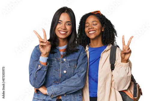 Latin friends ready for vacation joyful and carefree showing a peace symbol with fingers. photo