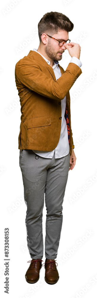 Young handsome business man wearing glasses tired rubbing nose and eyes feeling fatigue and headache. Stress and frustration concept. Young handsome business man wearing glasses tired rubbing nose and eyes feeling fatigue and headache. Stress and frustration concept.