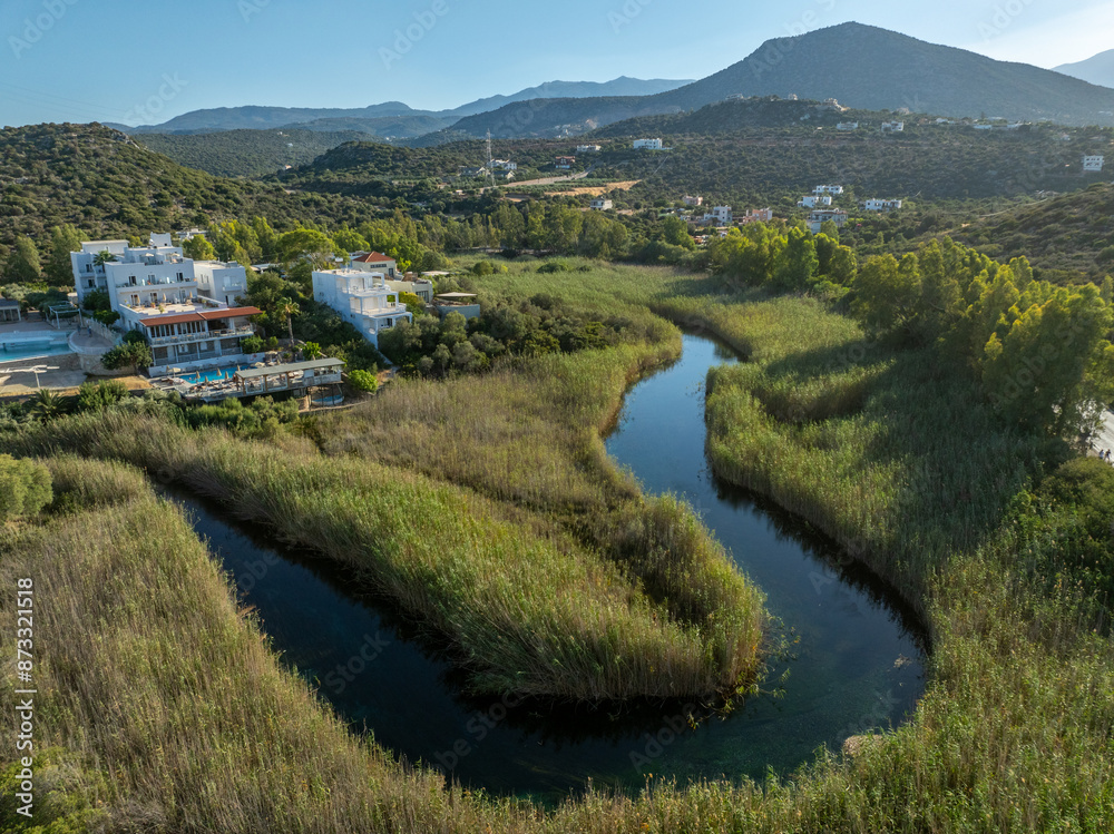 Fototapeta premium Greece - Crete - The famous Almyros beach is one of the most beautiful sandy beaches in Crete, with a small stream flowing into the sea nearby. The town of Agios Nikolaos is nearby