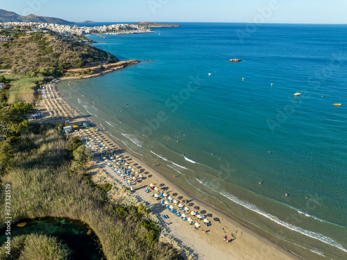 Fototapeta Naklejka Na Ścianę i Meble -  Greece - Crete - The famous Almyros beach is one of the most beautiful sandy beaches in Crete, with a small stream flowing into the sea nearby. The town of Agios Nikolaos is nearby