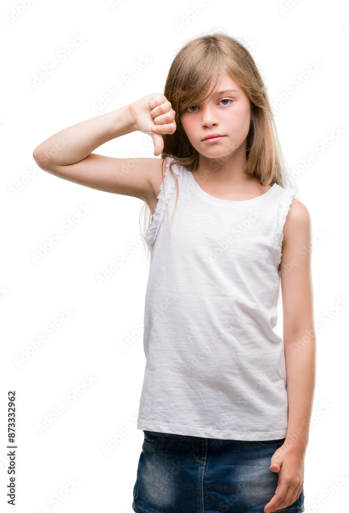 Young blonde toddler with angry face, negative sign showing dislike with thumbs down, rejection concept Young blonde toddler with angry face, negative sign showing dislike with thumbs down, rejection concept