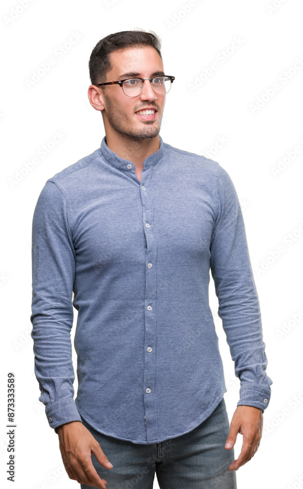 Handsome young elegant man wearing glasses looking away to side with smile on face, natural expression. Laughing confident. Handsome young elegant man wearing glasses looking away to side with smile on face, natural expression. Laughing confident.