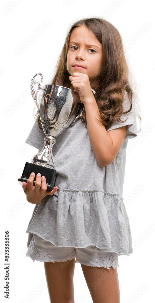 Brunette hispanic girl holding a trophy serious face thinking about question, very confused idea Brunette hispanic girl holding a trophy serious face thinking about question, very confused idea