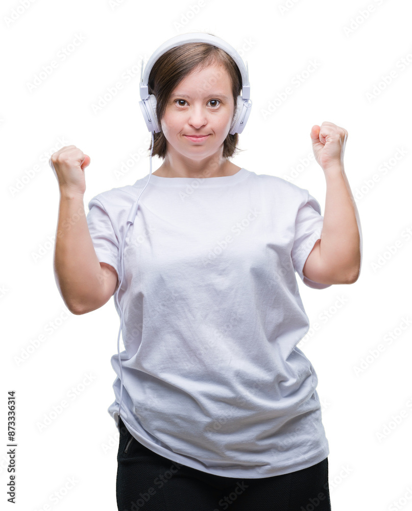 Young adult woman with down syndrome wearing headphones over isolated background very happy and excited doing winner gesture with arms raised, smiling and screaming for success. Celebration concept. Young adult woman with down syndrome wearing headphones over isolated background very happy and excited doing winner gesture with arms raised, smiling and screaming for success. Celebration concept.