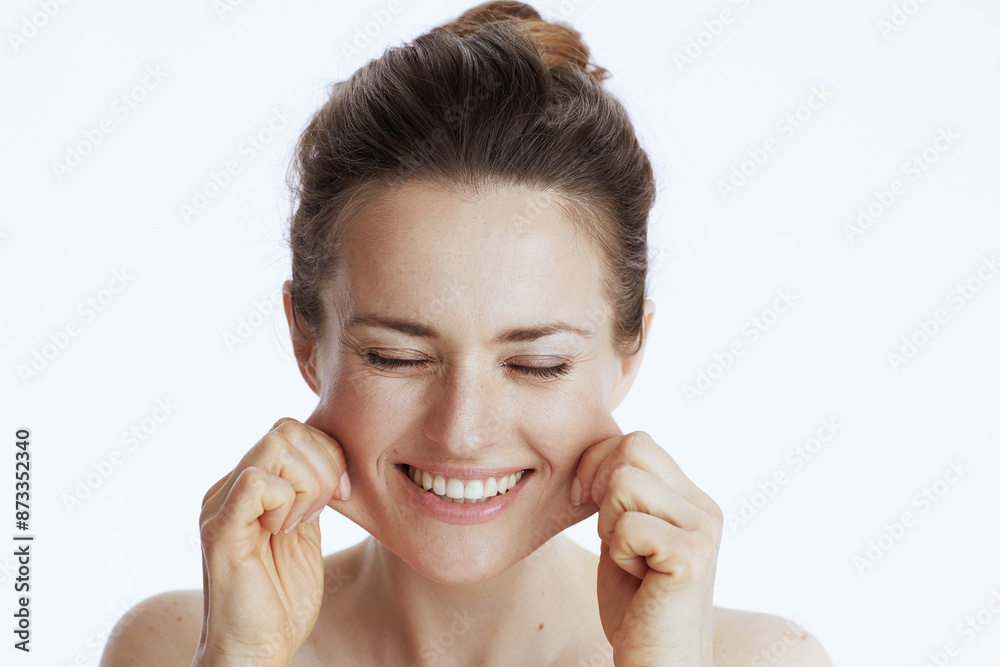 happy modern 40 years old woman doing facial massage happy modern 40 years old woman doing facial massage