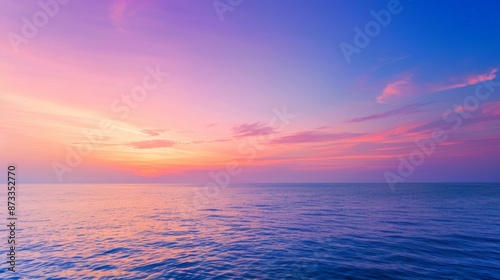 A tranquil ocean sunset with vibrant pink and purple illuminating the calm water, serene and breathtaking natural scene