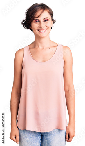 Beautiful young woman with short hair wearing casual style with sleeveless shirt with a happy and cool smile on face. lucky person.