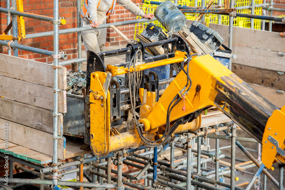 Yellow Construction Crane on Scaffolding Platform Yellow Construction Crane on Scaffolding Platform