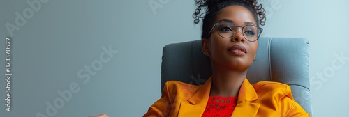 African american woman in yellow blazer with glasses, concept of intelligence and modern fashion. Perfect for illustrating Fashion Day photo