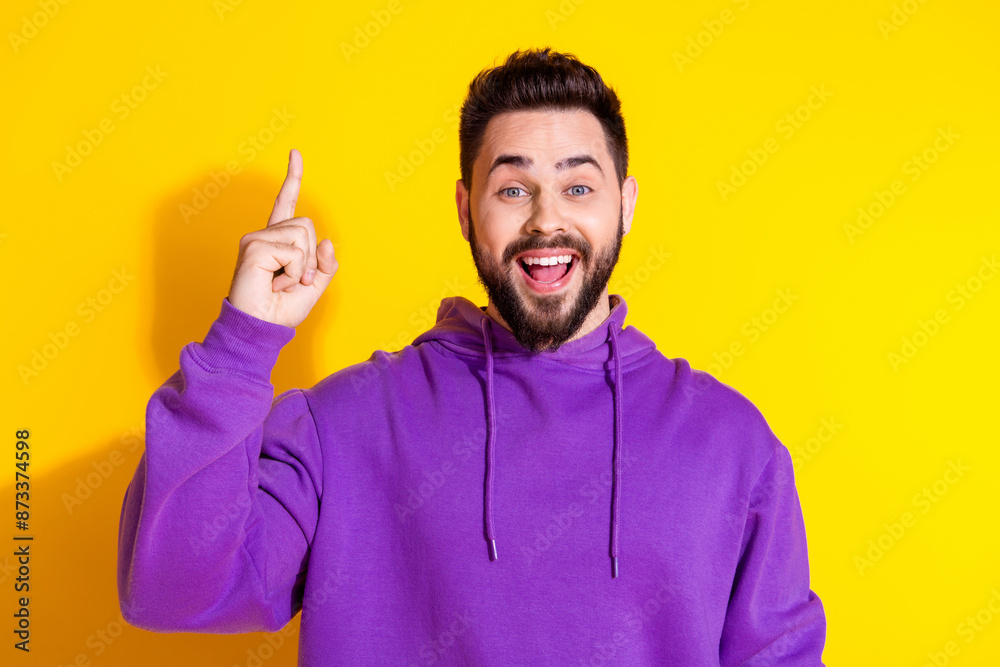 Photo of excited glad nice man wear purple stylish clothes yes idea finger up blank space isolated on yellow color background Photo of excited glad nice man wear purple stylish clothes yes idea finger up blank space isolated on yellow color background