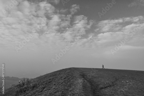 man walking up a hill photo