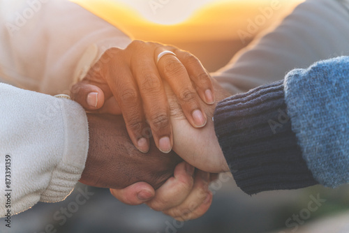 Close-up of Multicultural Diverse Hands Clasped Together at Sunset