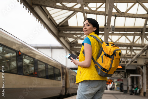 Young Woman Waiting for Train at Railway Station With Backpack © Iryna