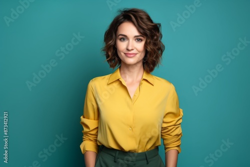 Photo of cool attractive business lady short hairstyle friendly smiling responsible person arms crossed wear casual green shirt yellow pants isolated blue color background
