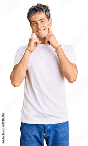 Young handsome man wearing casual white tshirt smiling with open mouth, fingers pointing and forcing cheerful smile