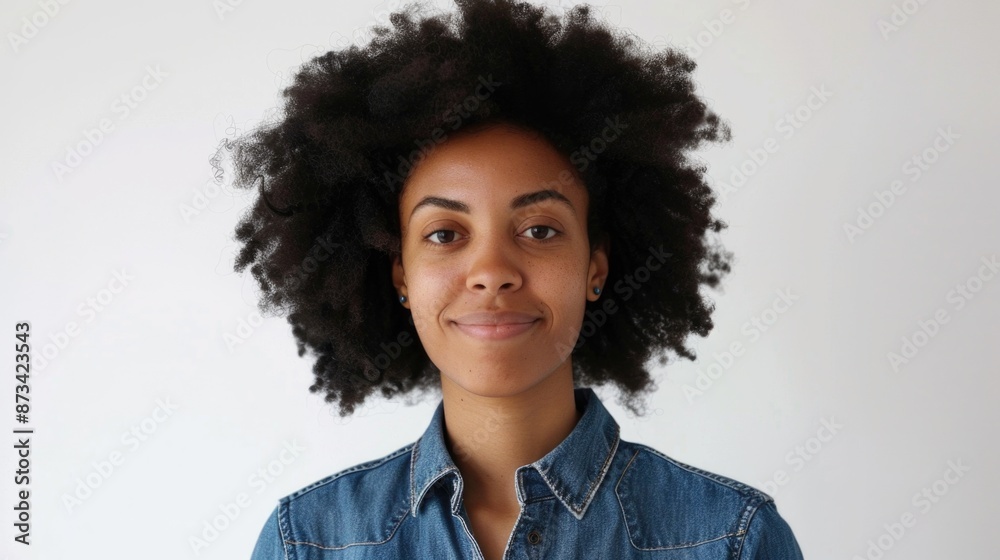 A woman with curly hair is smiling and wearing a blue shirt. Concept of happiness and positivity A woman with curly hair is smiling and wearing a blue shirt. Concept of happiness and positivity