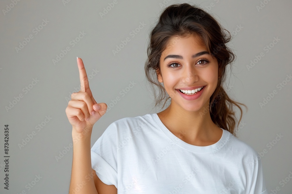 Happy Young Woman Pointing Up With a Big Smile