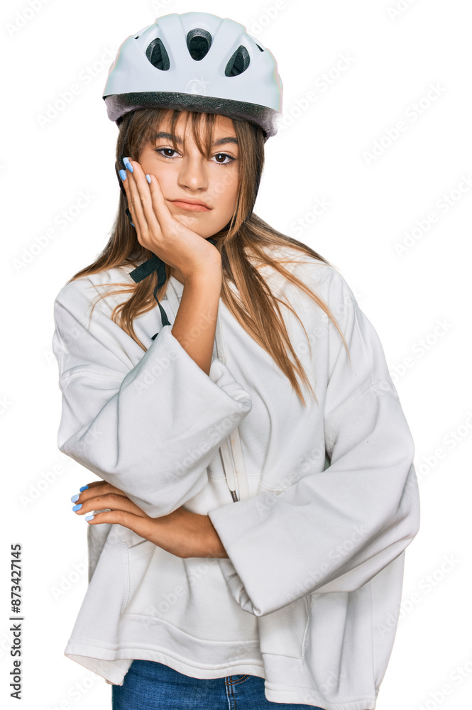 Teenager caucasian girl wearing bike helmet thinking looking tired and bored with depression problems with crossed arms. Teenager caucasian girl wearing bike helmet thinking looking tired and bored with depression problems with crossed arms.