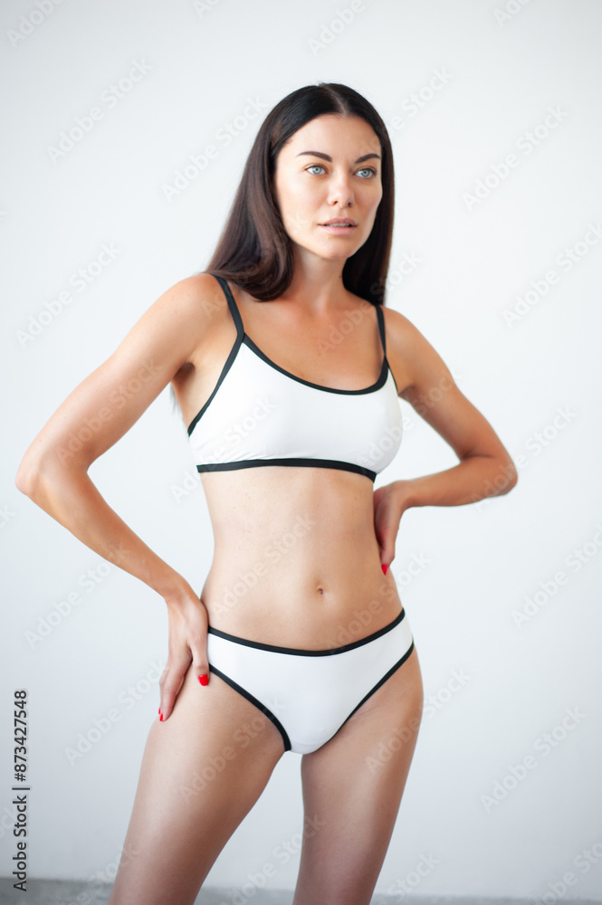 High fashion portrait of young beautiful sexy woman . Carefree model wearing black lingerie. Hot tanned woman isolated on white in studio. Model agency snapshot High fashion portrait of young beautiful sexy woman . Carefree model wearing black lingerie. Hot tanned woman isolated on white in studio. Model agency snapshot