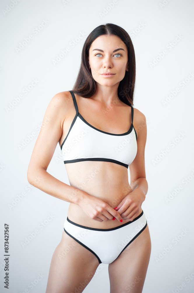 High fashion portrait of young beautiful sexy woman . Carefree model wearing black lingerie. Hot tanned woman isolated on white in studio. Model agency snapshot High fashion portrait of young beautiful sexy woman . Carefree model wearing black lingerie. Hot tanned woman isolated on white in studio. Model agency snapshot