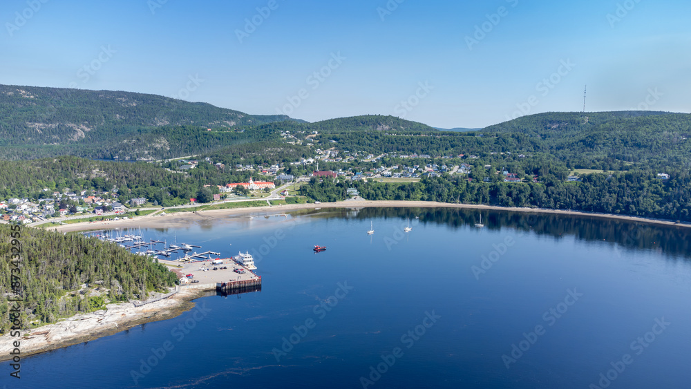 Naklejka premium Aerial view of Tadoussac bay and marina, taken by drone.