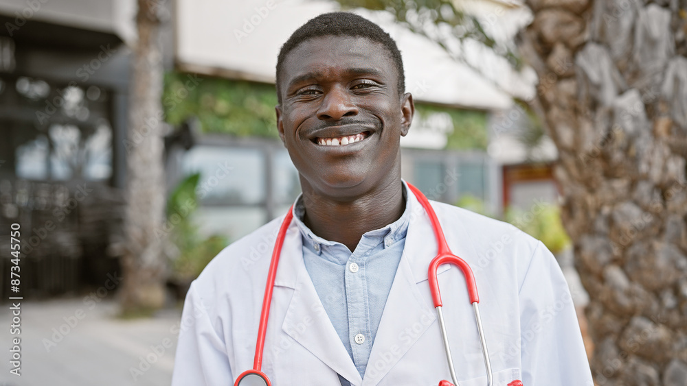 Handsome african male doctor smiling outdoors in an urban environment with casual attire Handsome african male doctor smiling outdoors in an urban environment with casual attire