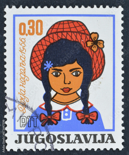 Cancelled postage stamp printed by Yugoslavia, that shows Girl with hat and promotes Children's Week, circa 1966.