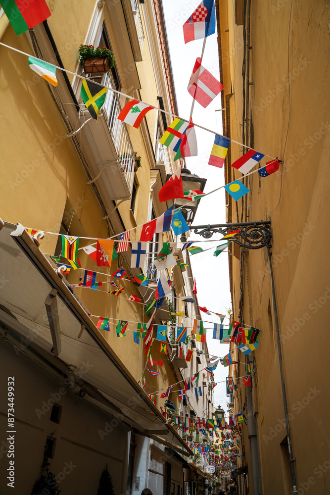 Sorrento, Italy - June 24, 2024: Narrow streets of Sorrento with shops and flags of different countries hanging on a rope
