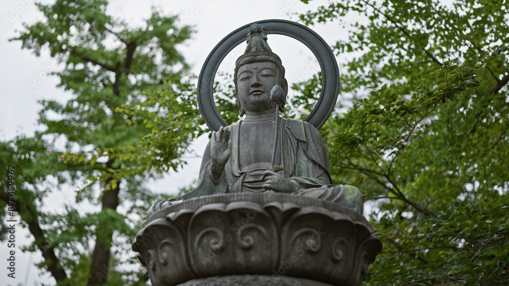 Serene buddha statue in contemplation amidst lush greenery, exemplifying spirituality and japanese culture. Serene buddha statue in contemplation amidst lush greenery, exemplifying spirituality and japanese culture.