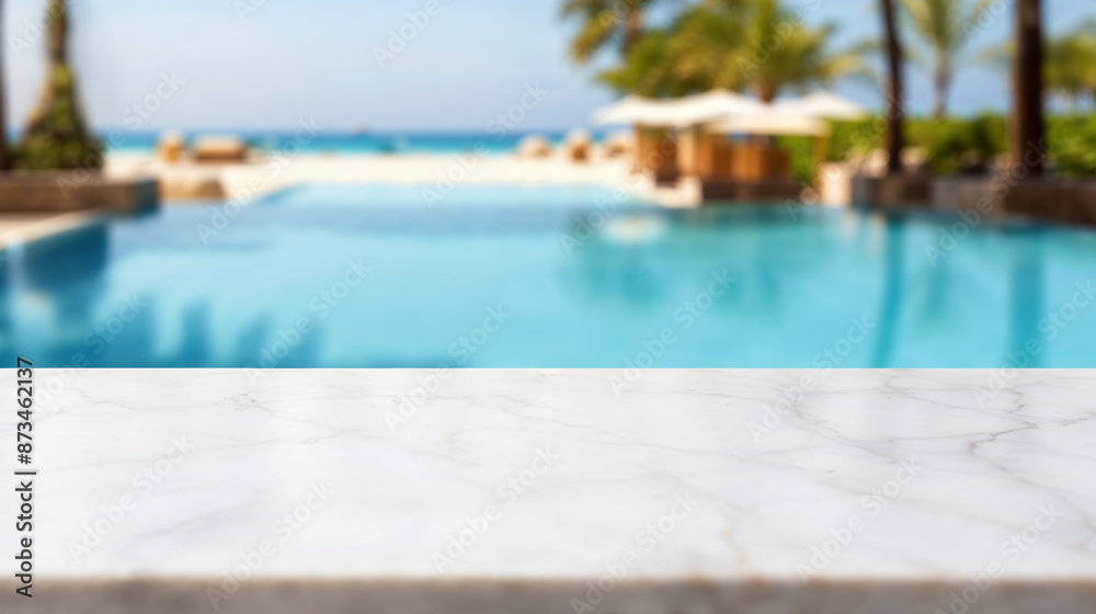 White marble counter top with blurred luxurious swimming pool and beach in the background White marble counter top with blurred luxurious swimming pool and beach in the background
