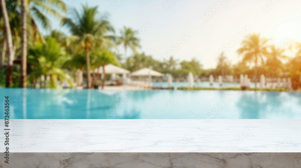 Blurred swimming pool background behind empty marble tabletop at resort hotel, perfect for product display montage Blurred swimming pool background behind empty marble tabletop at resort hotel, perfect for product display montage