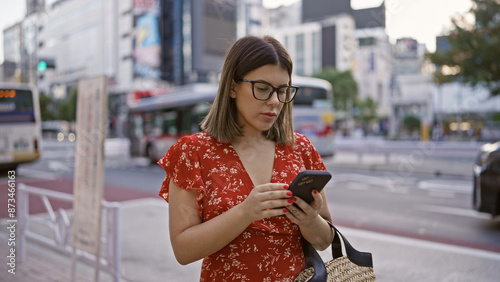 Photography Beautiful hispanic woman with glasses in tokyo, digital connection via smartphon