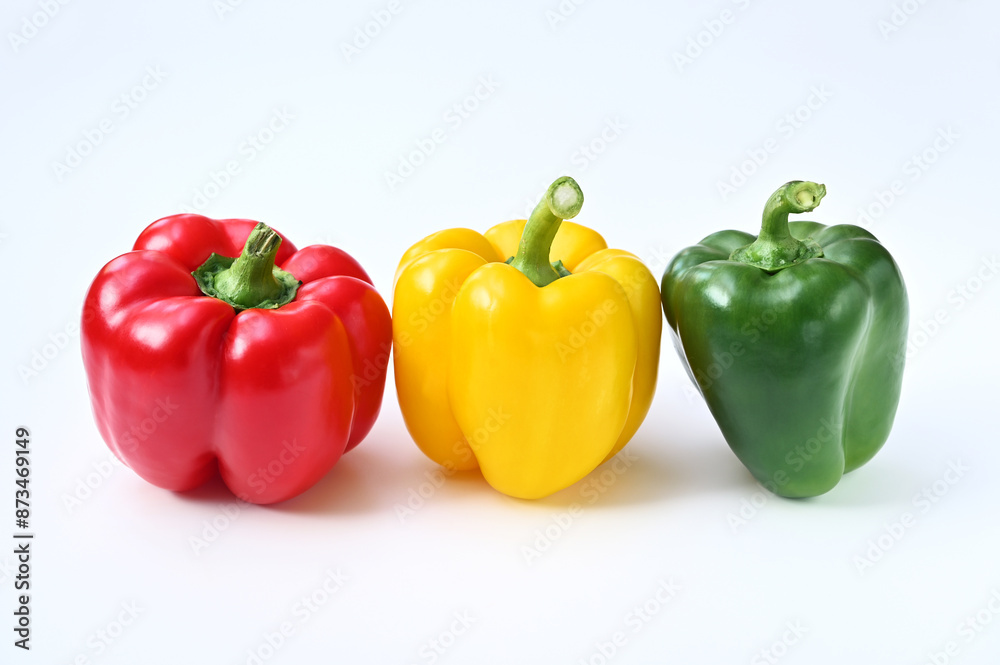 three colorful sweet bell peppers on a white background close-up three colorful sweet bell peppers on a white background close-up