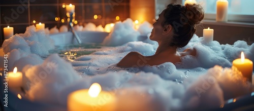 Woman enjoying a relaxing bubble bath with candles around, creating a serene and tranquil atmosphere. AIG62 photo