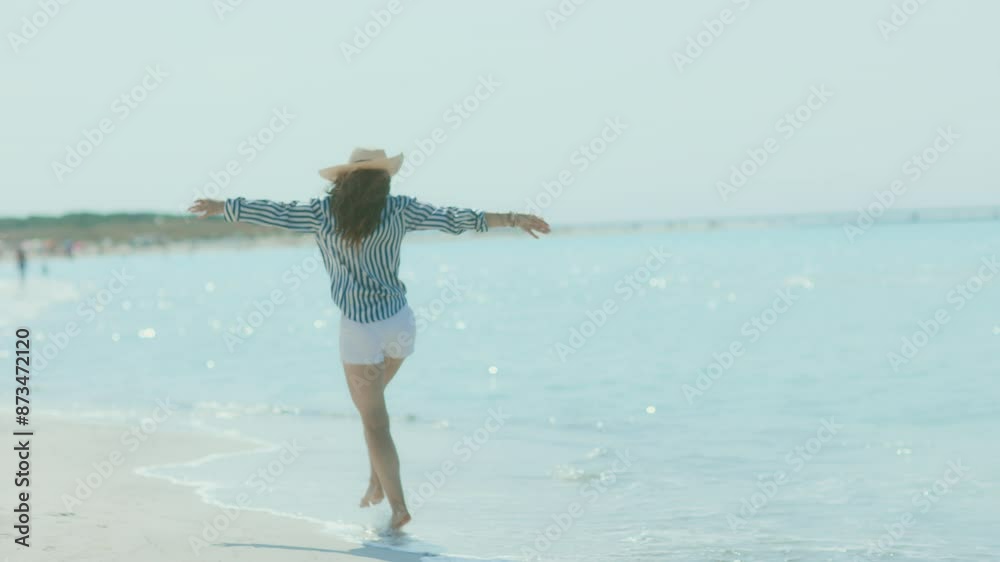 smiling elegant middle aged woman on the seashore with straw hat. smiling elegant middle aged woman on the seashore with straw hat.