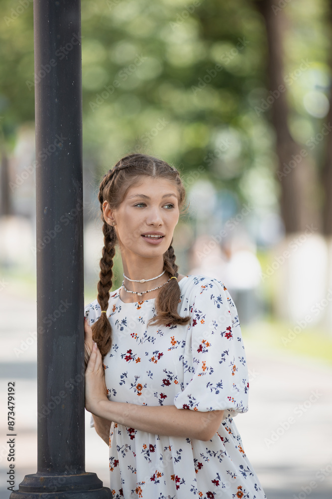 Joyful young woman wearing trendy outfit and walking at the sunny street Joyful young woman wearing trendy outfit and walking at the sunny street