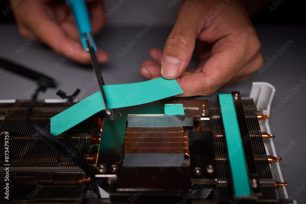 Technician assembling a GPU, focusing on installing computer hardware components Technician assembling a GPU, focusing on installing computer hardware components