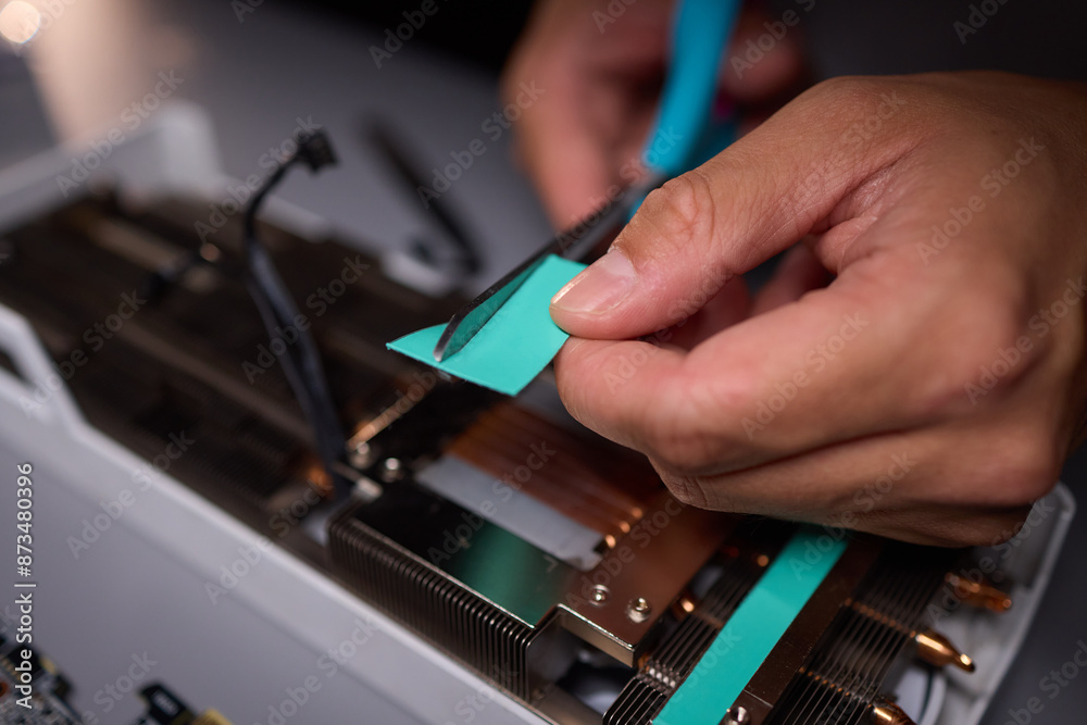 Technician assembling a GPU, focusing on installing computer hardware components Technician assembling a GPU, focusing on installing computer hardware components