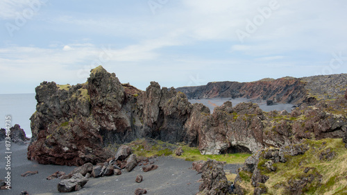 Icelandic seacape with volcanic rock formations and lava fields in summer near Dritvik, Snaefellsnes peninsula
