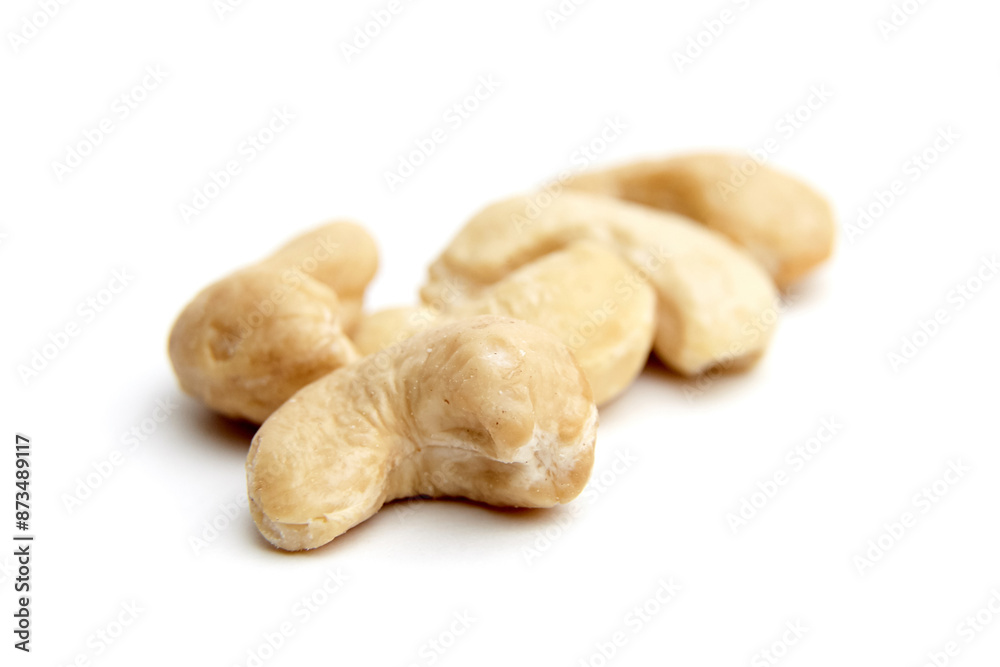 Close-up of several cashew nuts isolated on a white background. Ideal for illustrating healthy eating, snacks, and nutrition Close-up of several cashew nuts isolated on a white background. Ideal for illustrating healthy eating, snacks, and nutrition