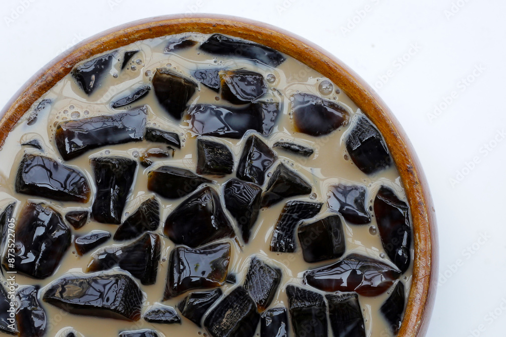 Fototapeta premium Grass jelly in milk with brown sugar, herbal dessert. Mesona chinensis