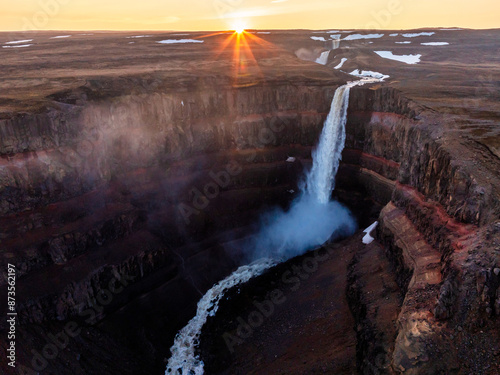 Aerial view on Hengifoss waterfall with red stripes sediments and old soil volcanic formation in Iceland. photo