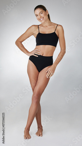 Body, portrait and girl with underwear in studio for fitness, confidence and wellness. Smile, health and happy woman in sportswear for self care, weight loss and diet results on white background.