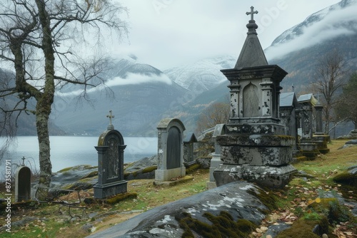 Peaceful graveyard by a lake with mistcovered mountains in the background