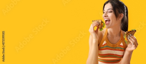 Happy young woman eating ta...