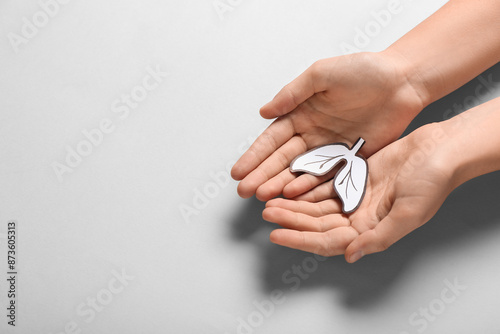 Female hands with paper lungs on grey background