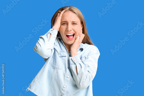 Emotional young woman suffe...