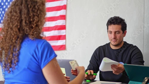 caucasian american person register in polling place, a young woman receives her election ballot during United States elections, democracy, civic participation, and the voting process