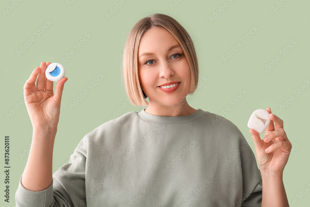 Woman with dental floss on green background Woman with dental floss on green background